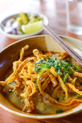 Thai Noodle Curry Soup with pork on wooden table
