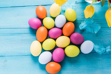 Many colored easter eggs on vibrant wooden table