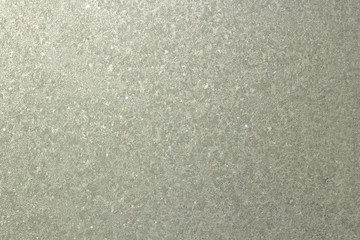Frozen window background. Ice on the glass. Grey