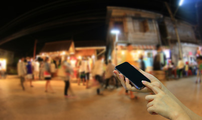 Hands holding smartphone. city background