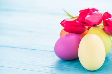 Easter eggs in pastel colors with tulips