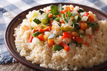 Couscous with seasonal vegetables close-up. horizontal
