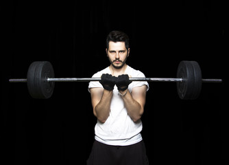 Fototapeta na wymiar Man doing weight lifting in gym on black background. Close up of