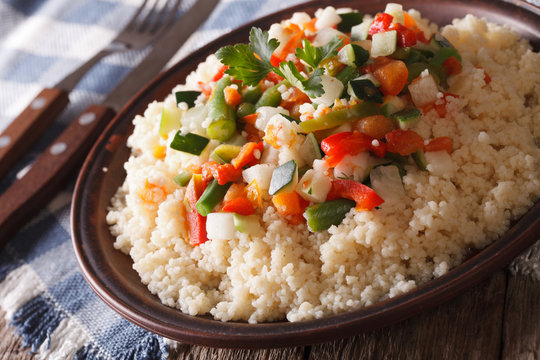 Asian Couscous with vegetables close-up on a plate. horizontal

