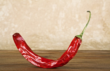 Red hot chili pepper on wood background