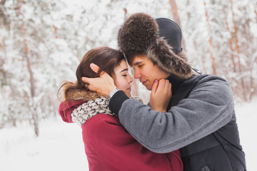 Fototapeta premium Happy Young Couple in Winter Park having fun.Family Outdoors. love