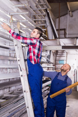 Fototapeta na wymiar Two workers choosing PVC window profile