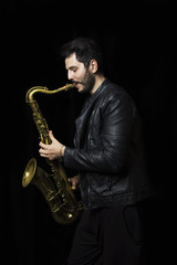 Fototapeta na wymiar A saxophone player in a dark background. Saxophone Player Saxoph