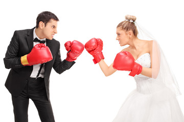 Young groom and a bride fighting each other