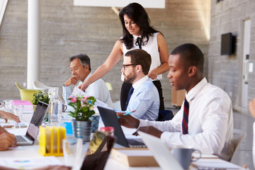 Businesswoman Working With Colleagues At Boardroom Table