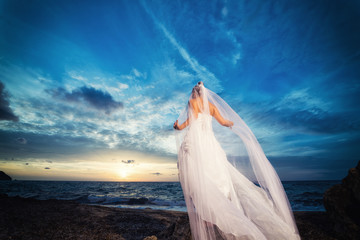 Fototapeta na wymiar bride on a tropical beach at sunset