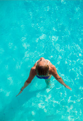 A girl is relaxing in a swimming pool