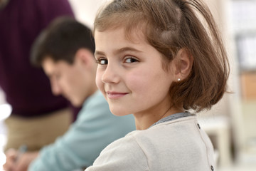 Portrait of smiling school girl in class