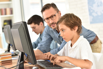 Teacher with kids in computing class