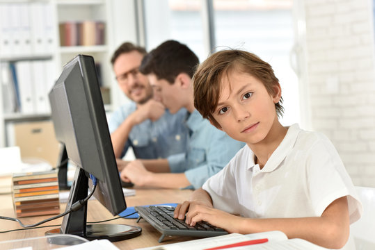 Portrait of 10-year-old schoolboy in computers lab