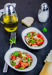 Fresh salad with tomatoes, lamb's lettuce, olives and onion