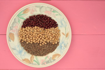 plate of various vegetables on pink background
