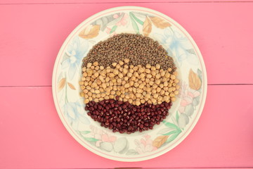 plate of various vegetables on pink background

