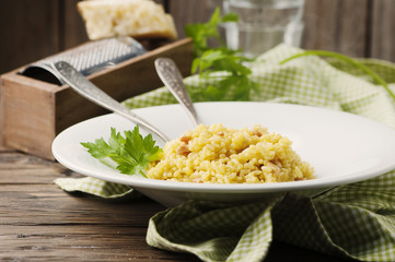 Italian traditional risotto with saffron and ham