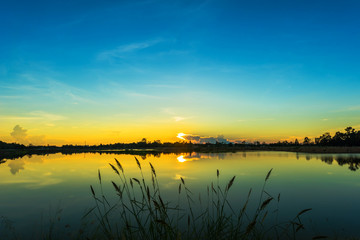 Sunset landscape with blue sky over the calm lake
