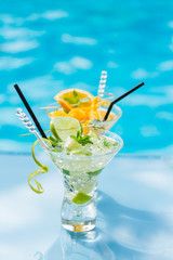 Mohito mojito drink with ice mint and lime near pool