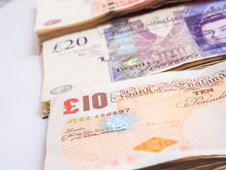 Bundle of pound currency on white