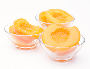 Cut peaches in syrup isolated on white