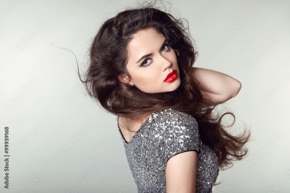 Wall mural Beauty Portrait of beautiful brunette woman with red lips and cu