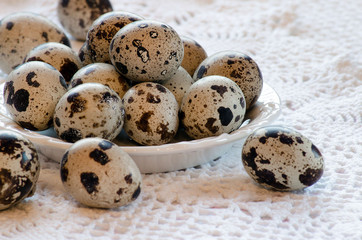 Quail eggs lying on a white plate