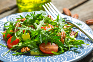 Green salad with avocado, cherry tomatoes and pecan