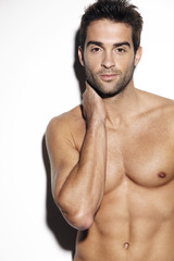 Fototapeta premium Young muscular man posing in studio