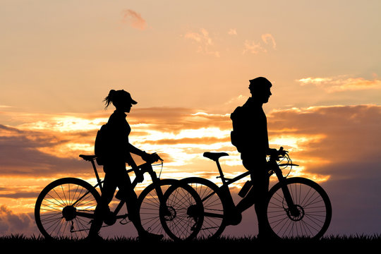 couple with bike at sunset