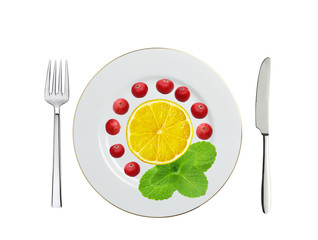 plate with cranberry, lemon slice and mint herb, spoon and fork