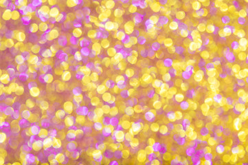 Pink and golden defocused glitter background.