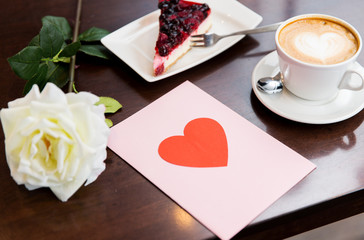 close up of greeting card with heart and coffee
