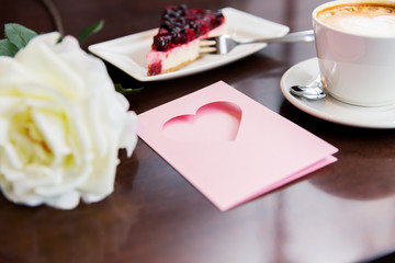 close up of greeting card with heart and coffee