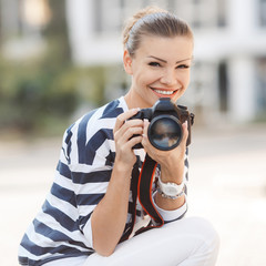 The beautiful female photographer with the digital camera