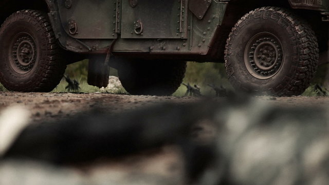 Machine gun near a military jeep.