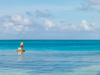 Fototapeta na wymiar Young fishermen with clear blue sea and sky