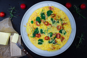 English Omelette with Butter and Tomatoes on Dark Background, Horizontal