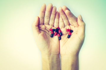 hands holding medicine capsule