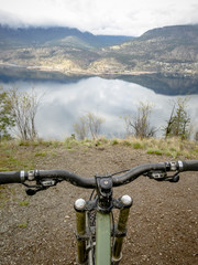 Bike on Steep Trail above Mountain lake Below
