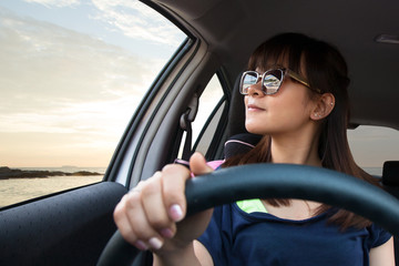 Woman driving and enjoy with happy vacations