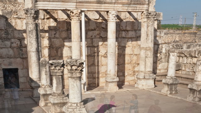 Dolly time-lapse of tourists at the old synagogue in Capernuam, Israel. Cropped.