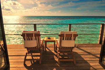 Seaside balcony with two chairs