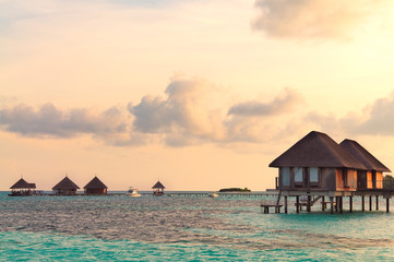 Sunrise over water bungalows in Maldives