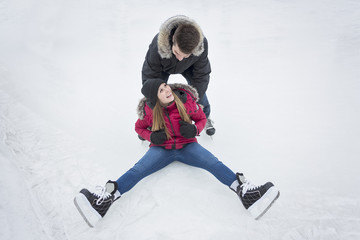 Ice skating couple having winter fun on ice skates Quebec, Canada.