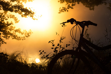 Fototapeta na wymiar Bike on the lake in front of the setting sun