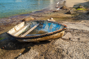 Peaceful scene in the morning, with a fishing boat ,on the shore of the Capri Island