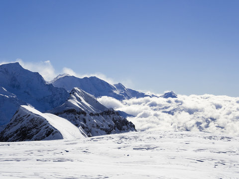 View from Les Grandes Platieres in Le Grand Massif to snowcapped mountains above cloud in the valley in the French Alps. Flaine 1600 - 2500 Haute Savoie Rhone-Alpes France Europe